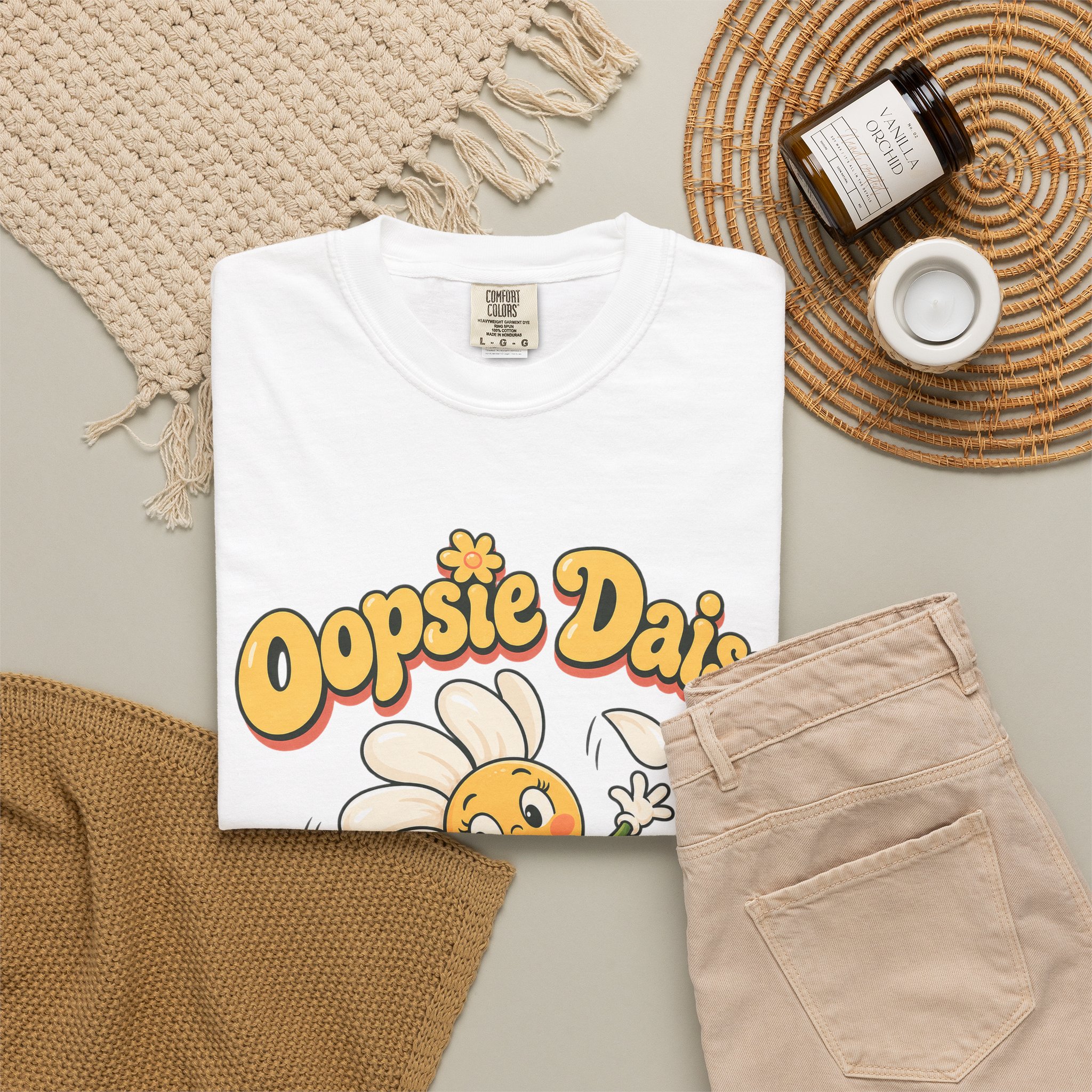 Folded Oopsie Daisy garment dyed tee in a flat lay