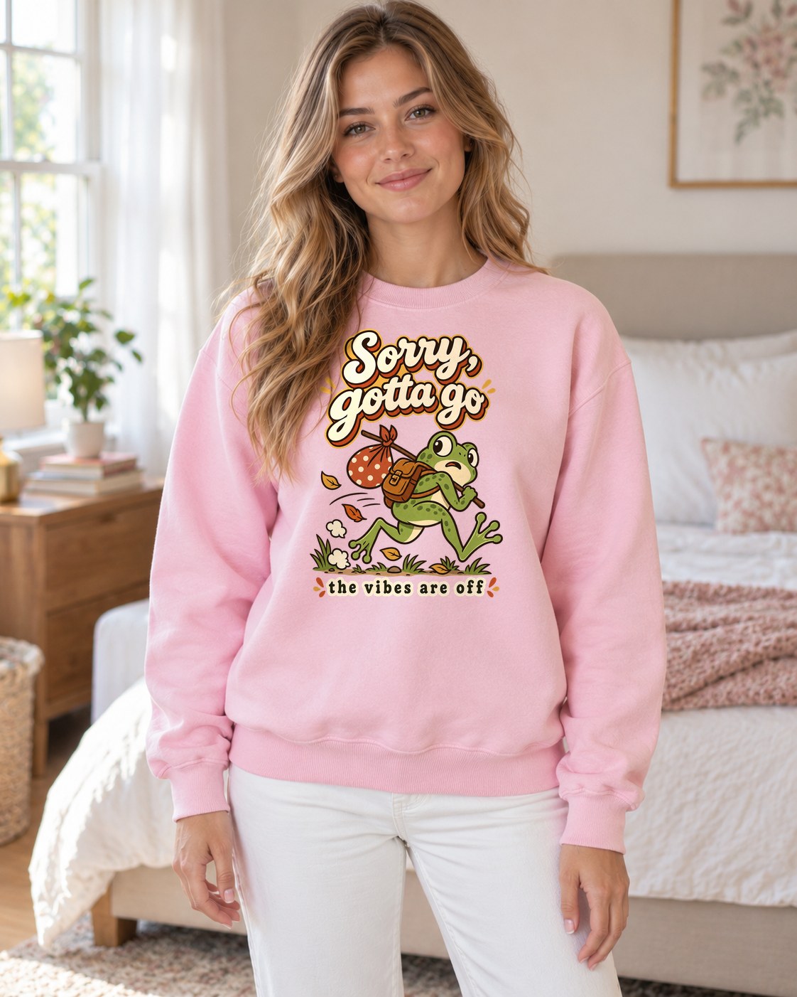 Sorry Gotta Go Frog Crewneck Sweatshirt in light pink worn by a model