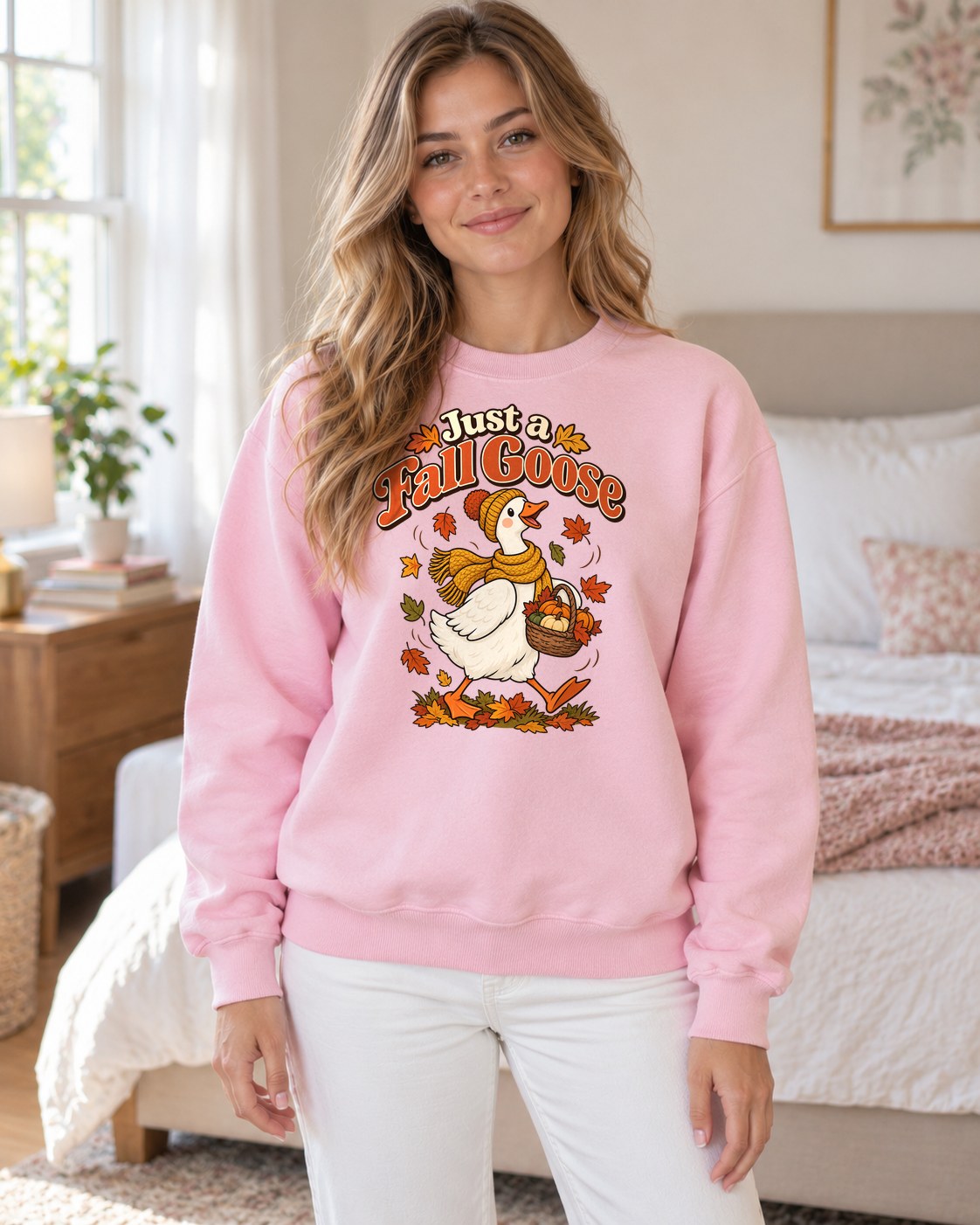 Just a Fall Goose Crewneck Sweatshirt in light pink worn by a model